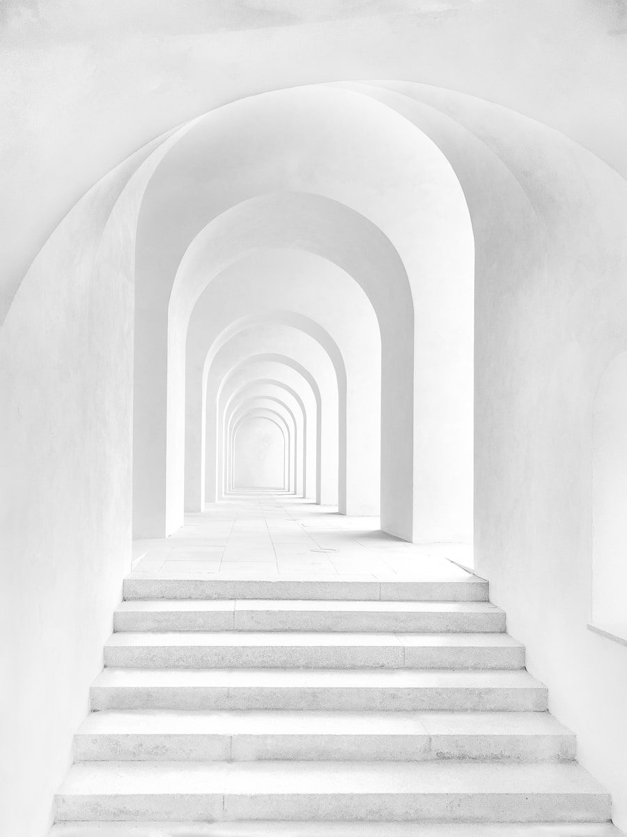 white archway corridor with stairs